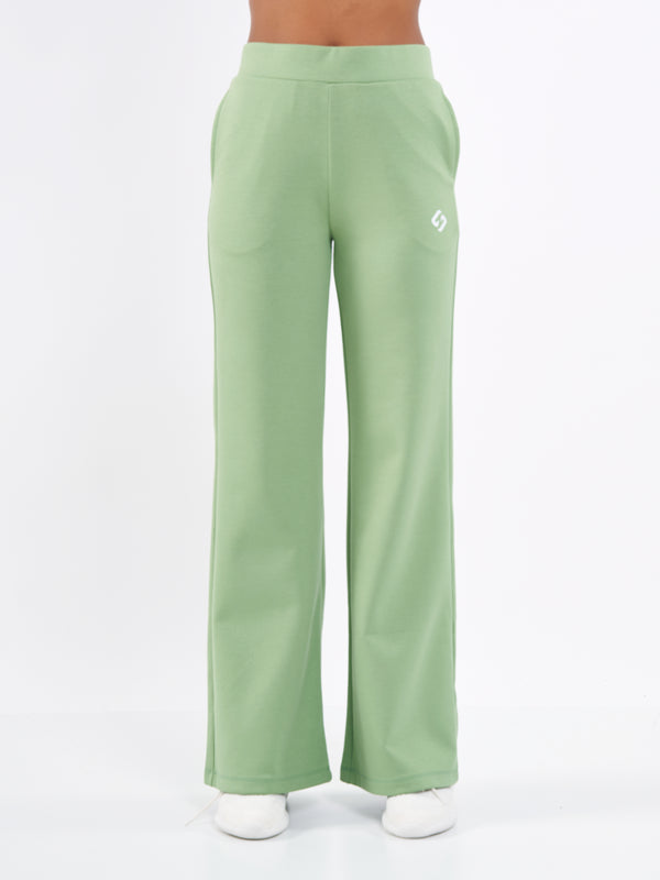 Color_Misty Green | A Woman Wearing Misty Green Color Durable Flare-Leg Comfort Joggers for All-Day Wear