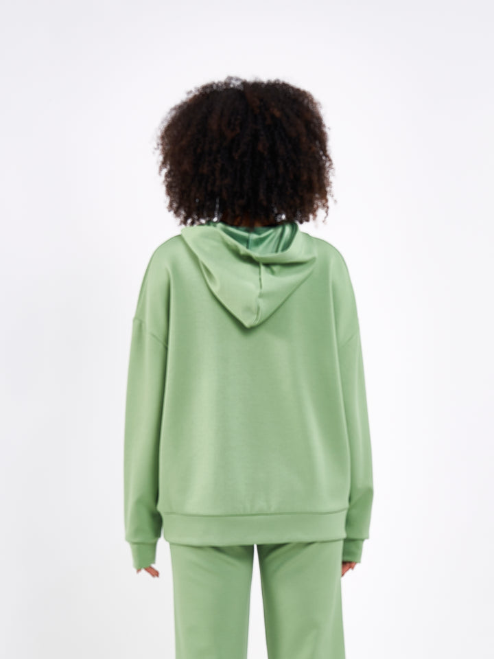 A Woman Wearing Misty Green Color Durable Oversized Comfort Hoodie for All-Day Wear