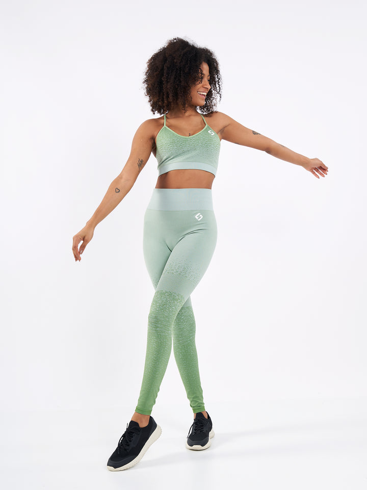 A Woman Wearing Misty Green Color Seamless Low-Impact Sports Bra with Ombre Effect. Chic Comfort