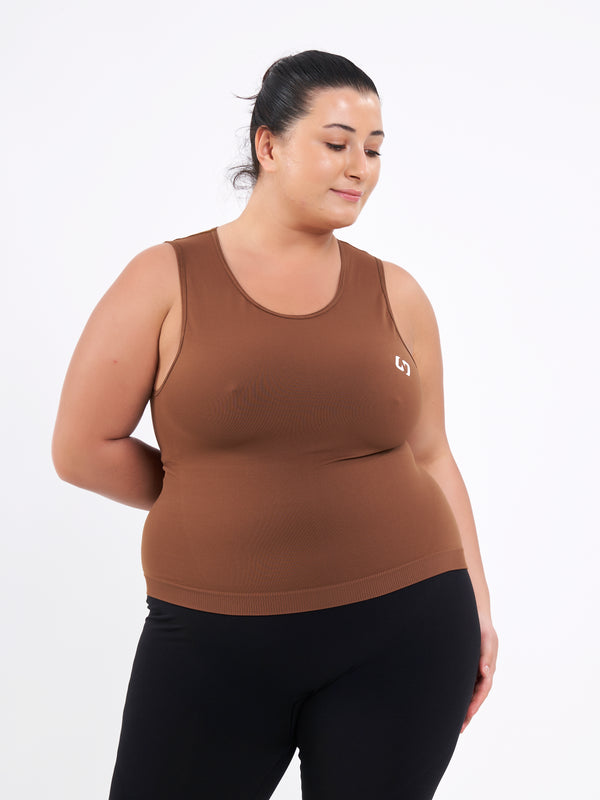 Color_Leather Brown | A Women Wearing Toffee Color Zen Confidence Seamless Compressive Crop Top. Sculpted Silhouette
