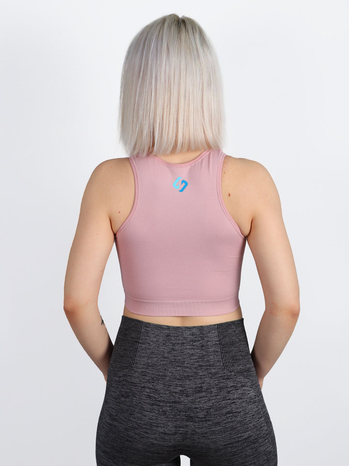 A Woman Wearing Blush Color All-Day Seamless Sleeveless Crop Top