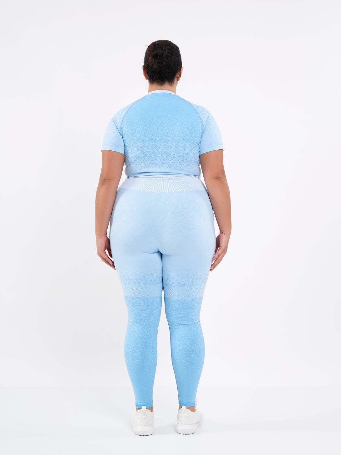 A Women Wearing Sky Blue Color Seamless High-Waist Leggings with Ombre Effect. Chic Comfort