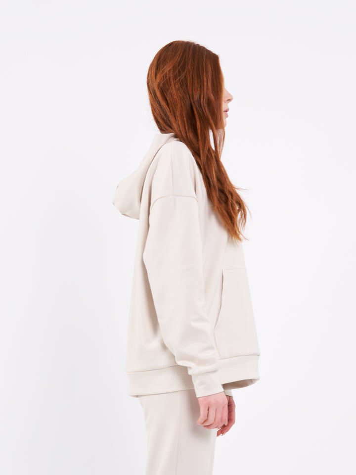 A Woman Wearing Sand Dune Color Durable Oversized Comfort Hoodie for All-Day Wear