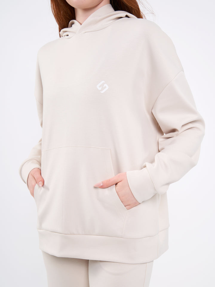 A Woman Wearing Sand Dune Color Durable Oversized Comfort Hoodie for All-Day Wear
