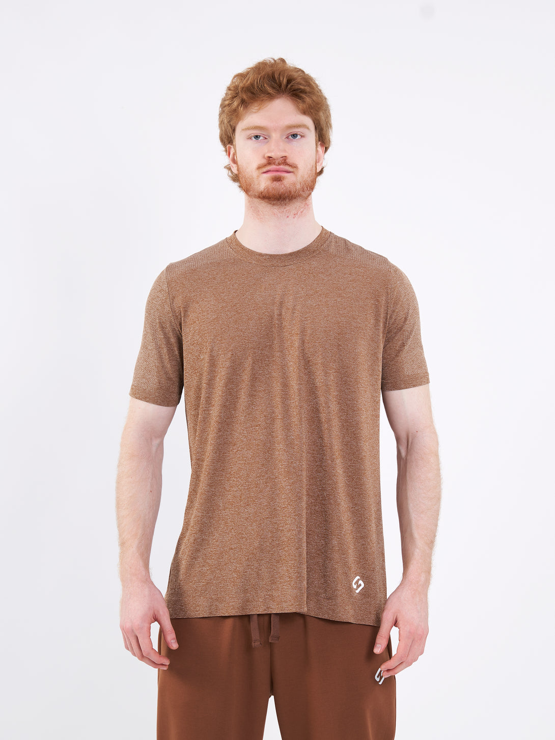 A Man Wearing Toffe Brown Color Unisex Seamless Melange T-Shirt. Enhanced Comfort