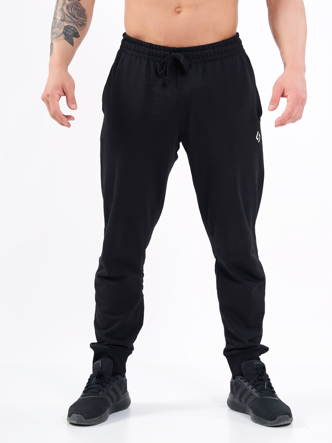 A Man Wearing Deep Black Color Men's Essential Comfort Joggers. Regular Fit