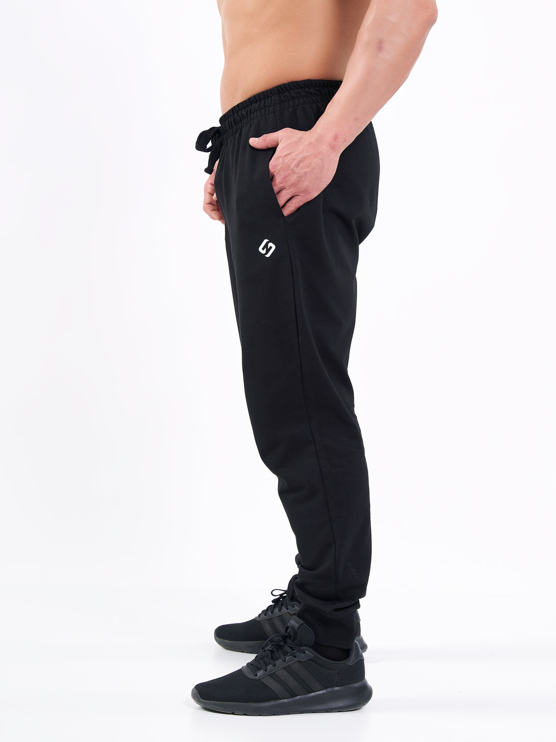 A Man Wearing Deep Black Color Men's Essential Comfort Joggers. Regular Fit