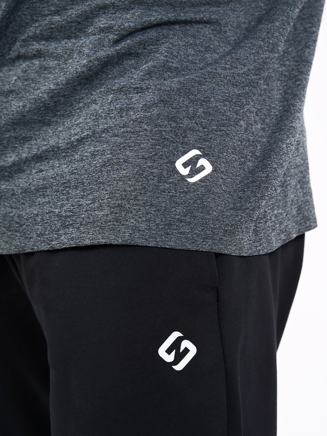 A Man Wearing Deep Black Color Unisex Seamless Melange T-Shirt. Enhanced Comfort