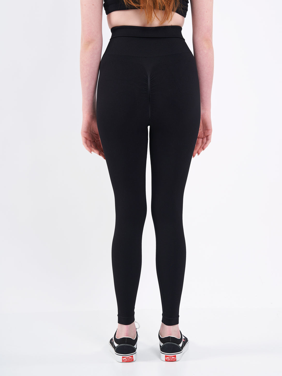 A Women Wearing Deep Black Color Zen Confidence Seamless Compressive Leggings. Body-Shaping