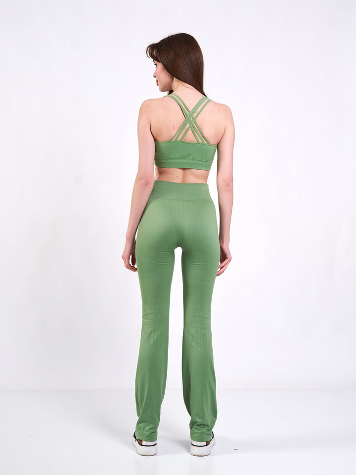 A Woman Wearing Misty Green Color Antigravity Seamless Flare-Leg Yoga Pants. Ultra-Light