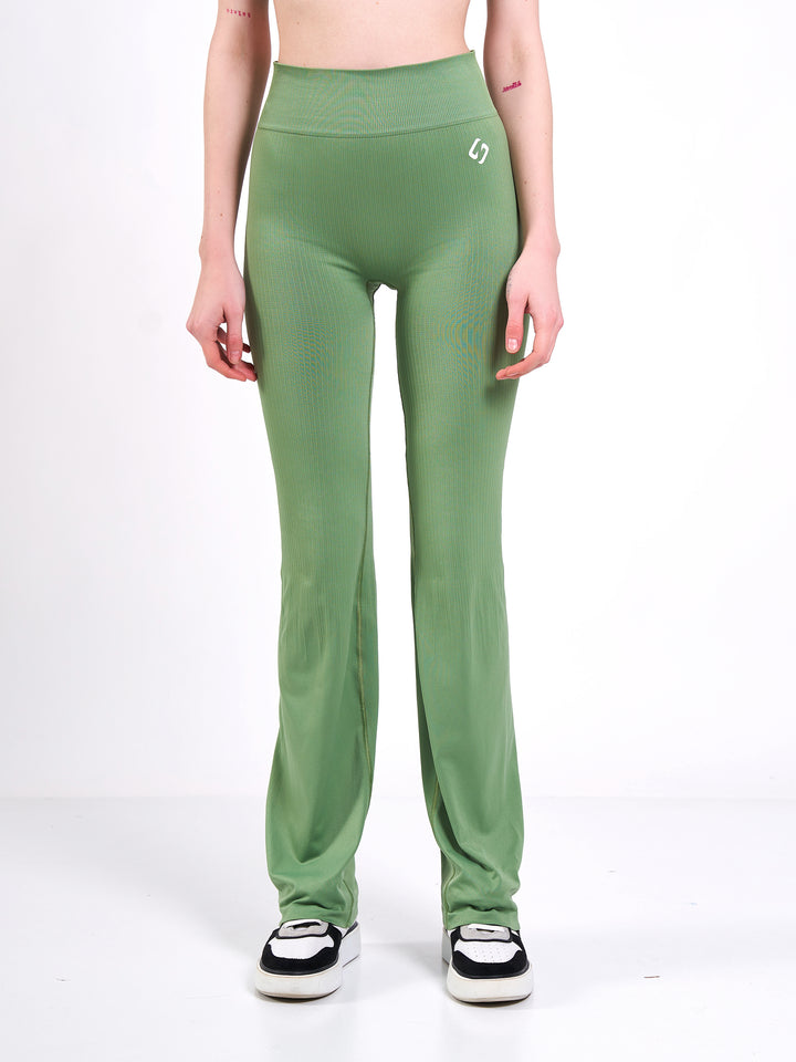 A Woman Wearing Misty Green Color Antigravity Seamless Flare-Leg Yoga Pants. Ultra-Light