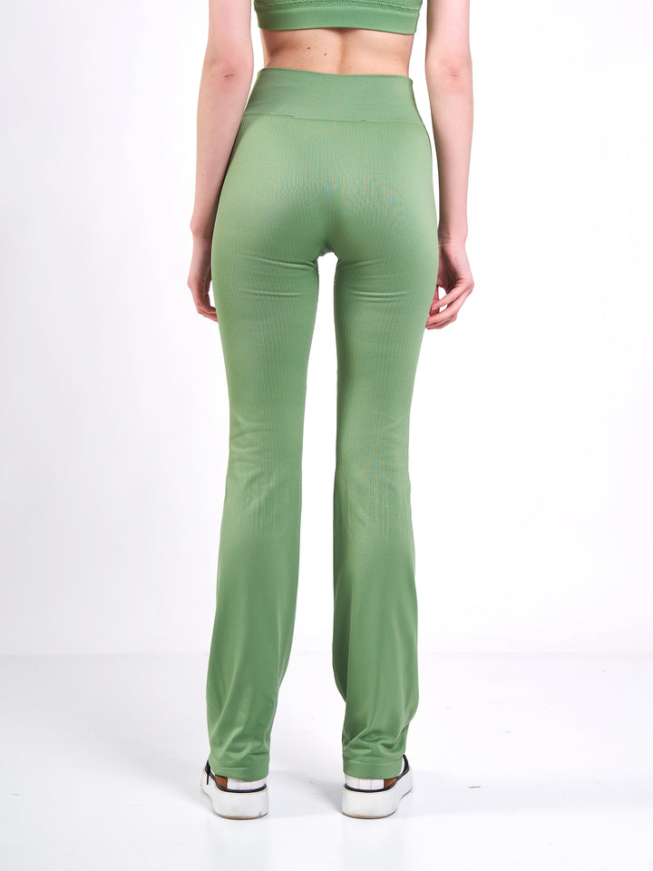 A Woman Wearing Misty Green Color Antigravity Seamless Flare-Leg Yoga Pants. Ultra-Light