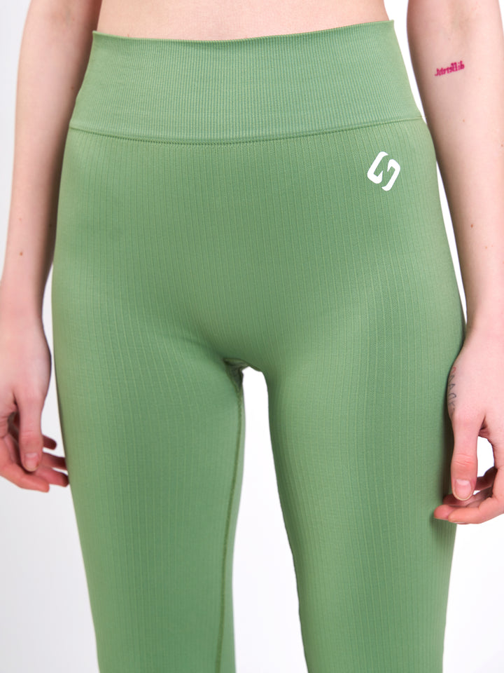 A Woman Wearing Misty Green Color Antigravity Seamless Flare-Leg Yoga Pants. Ultra-Light