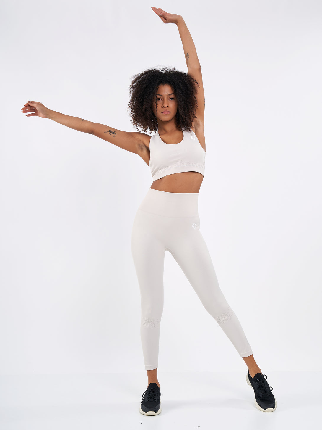 A Woman Wearing White Sand Color Seamless High-Waist Ankle-Length Ribbed Leggings. Super-Soft