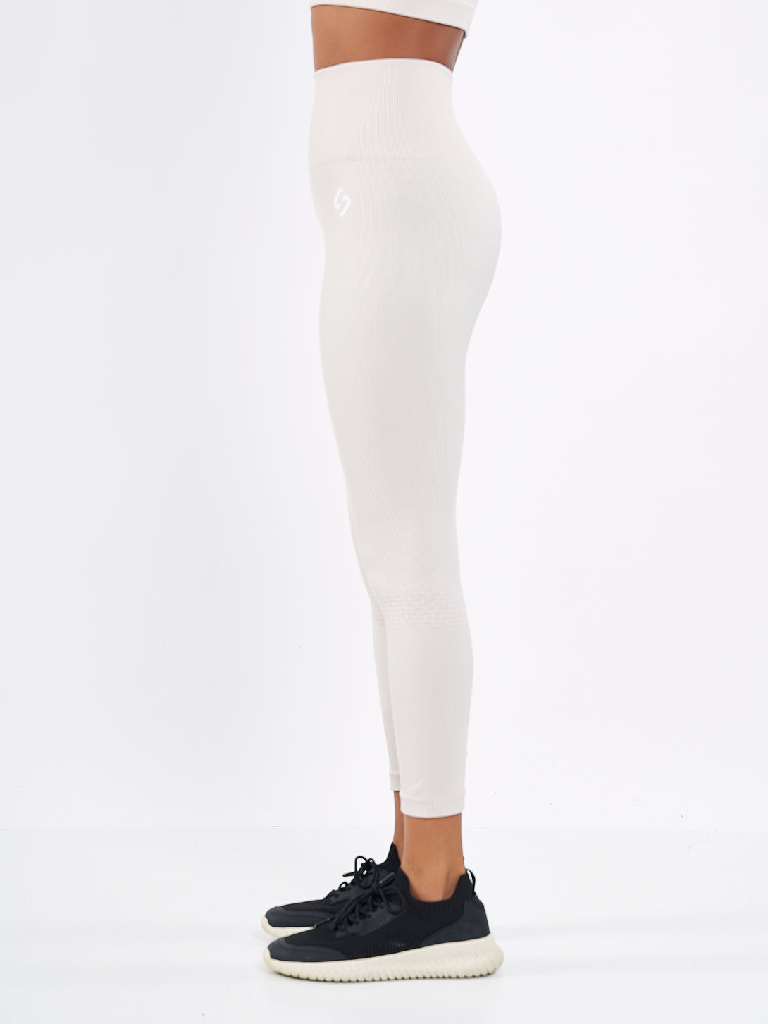 A Woman Wearing White Sand Color Seamless High-Waist Ankle-Length Ribbed Leggings. Super-Soft