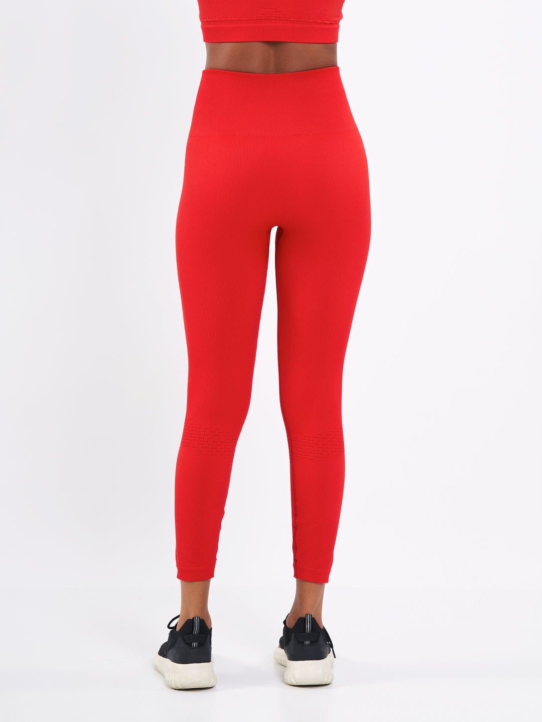 A Woman Wearing Bright Red Color Seamless High-Waist Ankle-Length Ribbed Leggings. Super-Soft