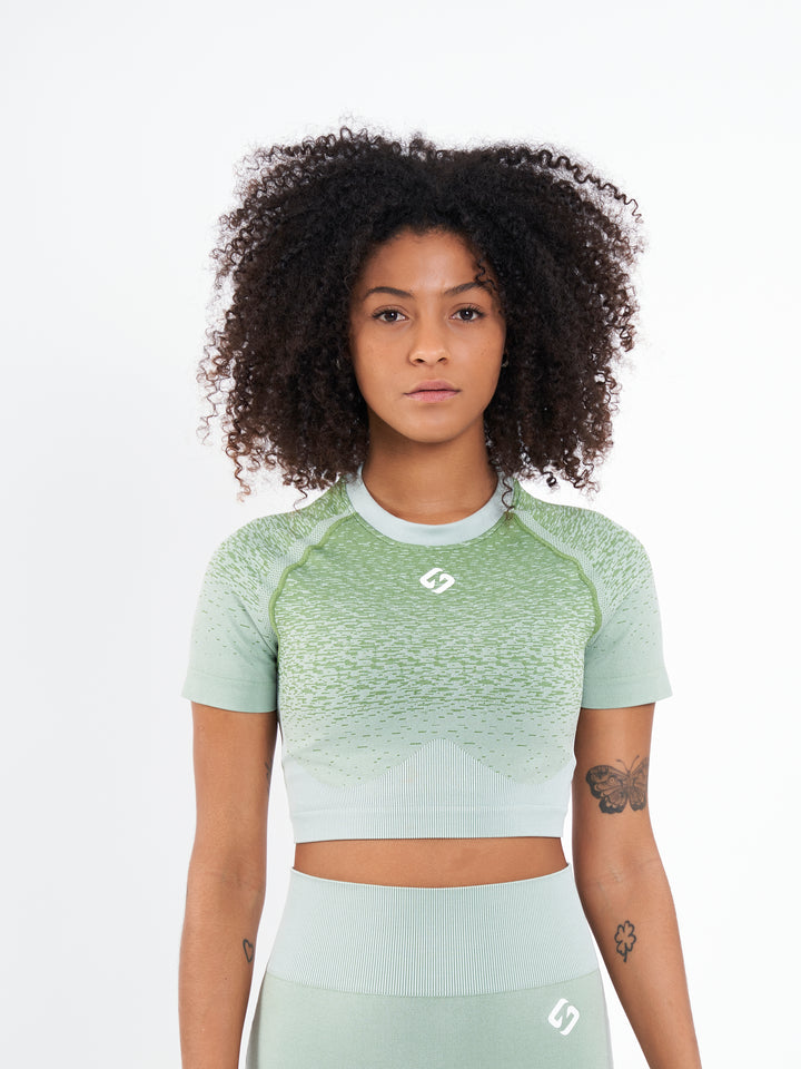 A Woman Wearing Misty Green Color Seamless Crop Top with Ombre Effect. Chic Comfort