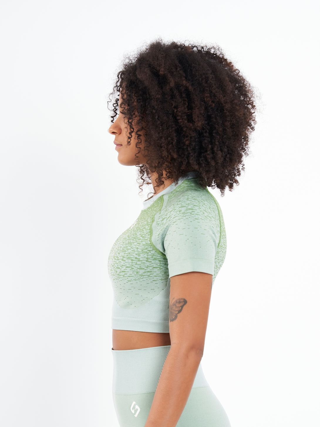 A Woman Wearing Mist Green Color Seamless Crop Top with Ombre Effect. Chic Comfort