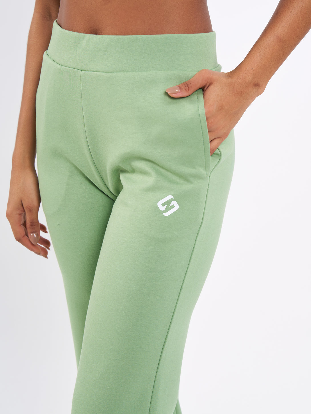 A Woman Wearing Mist Green Color Durable Flare-Leg Comfort Joggers for All-Day Wear