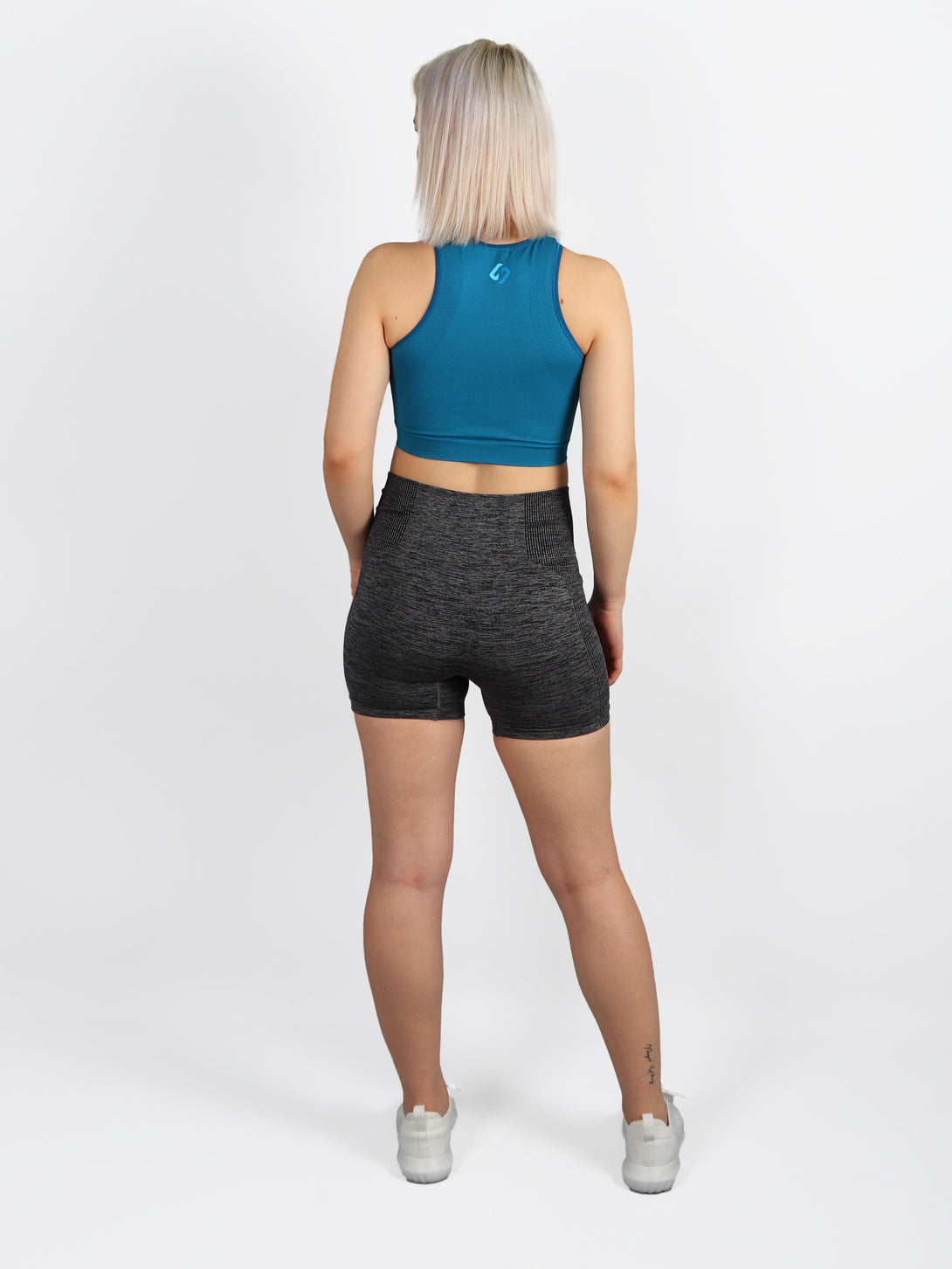 A Woman Wearing Saxony Blue Color All-Day Seamless Sleeveless Crop Top