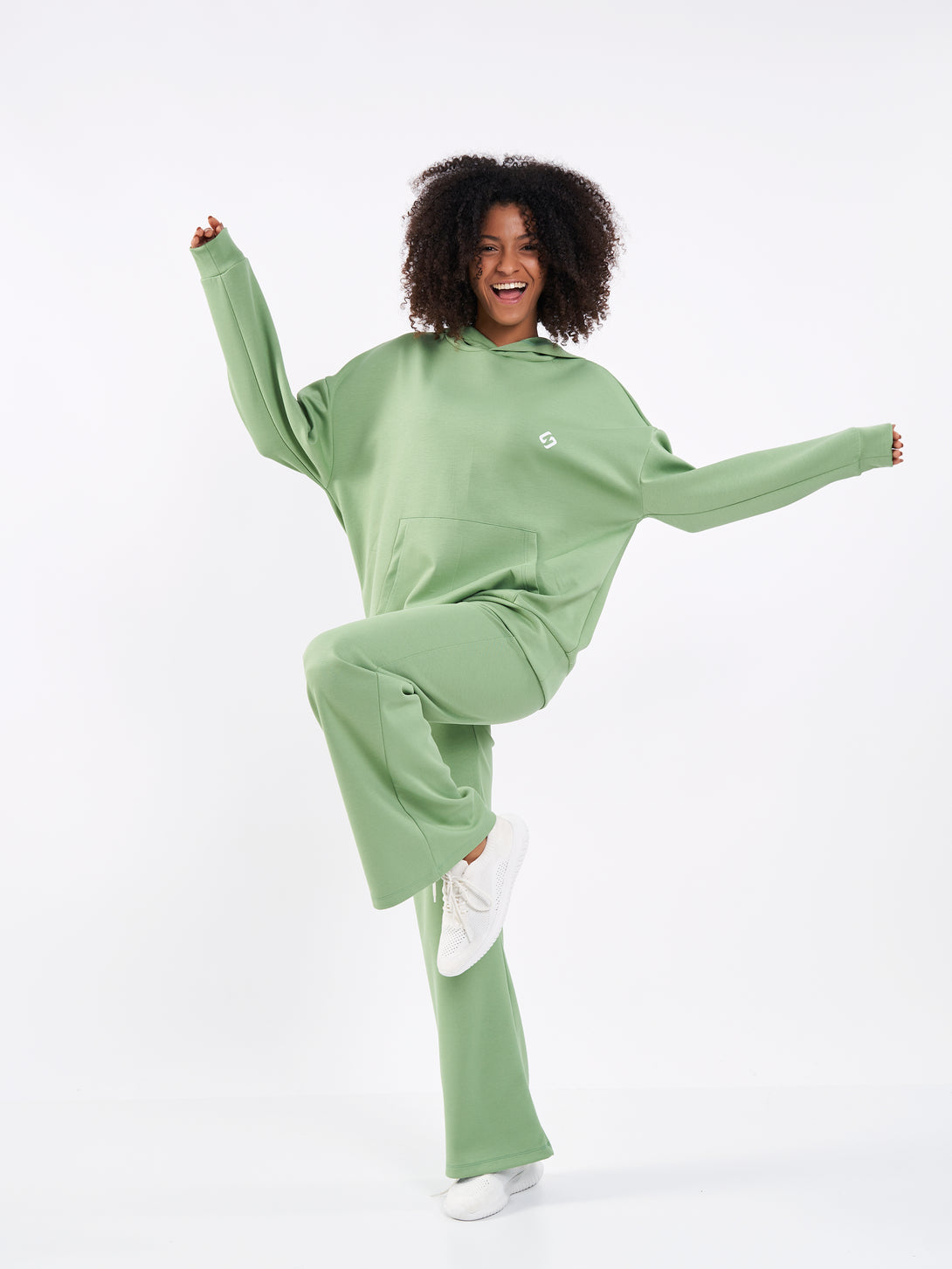 A Woman Wearing Mist Green Color Durable Flare-Leg Comfort Joggers for All-Day Wear