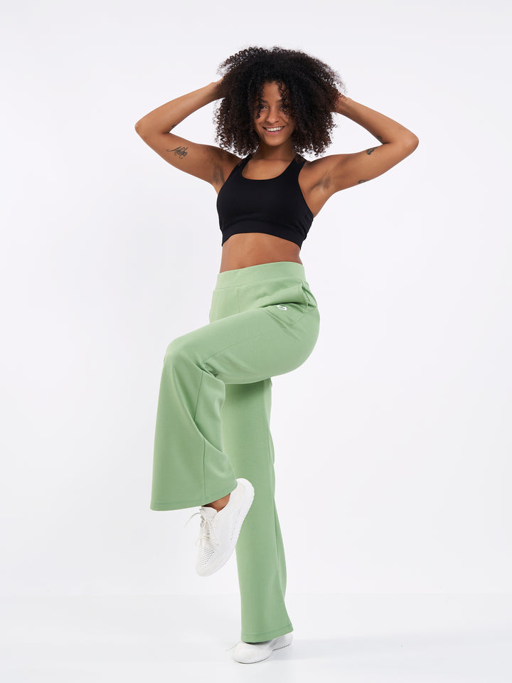 A Woman Wearing Misty Green Color Durable Flare-Leg Comfort Joggers for All-Day Wear
