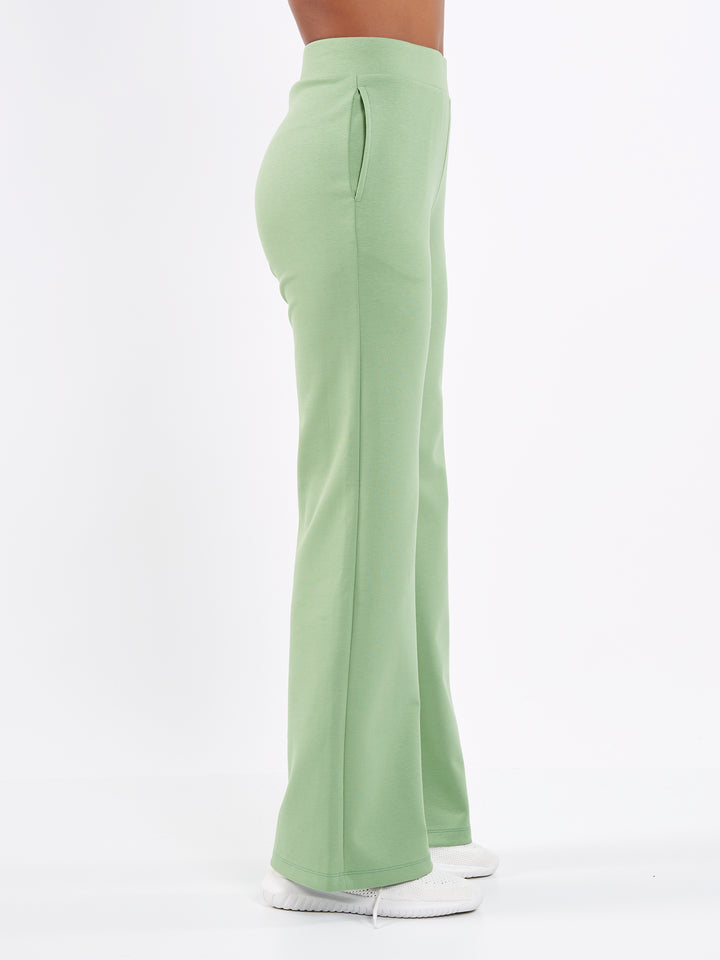 A Woman Wearing Misty Green Color Durable Flare-Leg Comfort Joggers for All-Day Wear