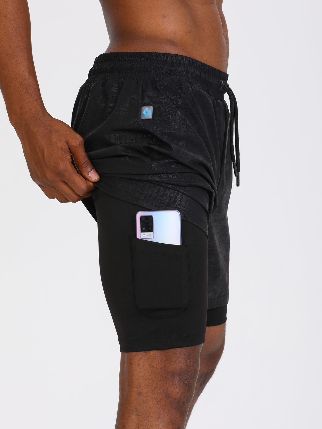 A Man Wearing Black Color Double Layered Mens Shorts