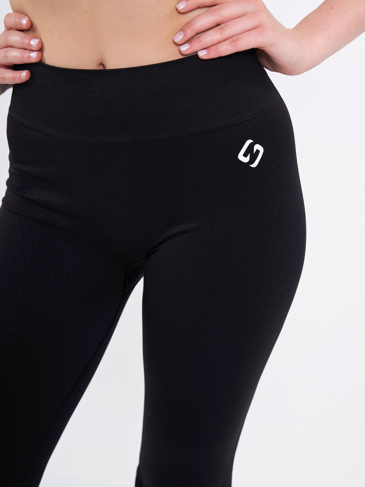 A Woman Wearing Deep Black Color Antigravity Seamless Flare-Leg Yoga Pants. Ultra-Light