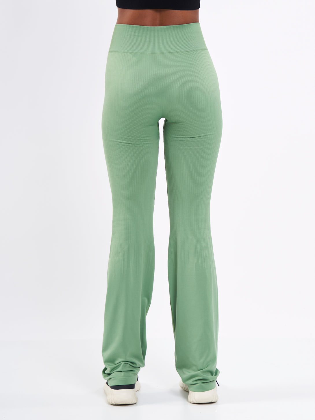A Woman Wearing Mist Green Color Antigravity Seamless Flare-Leg Yoga Pants. Ultra-Light
