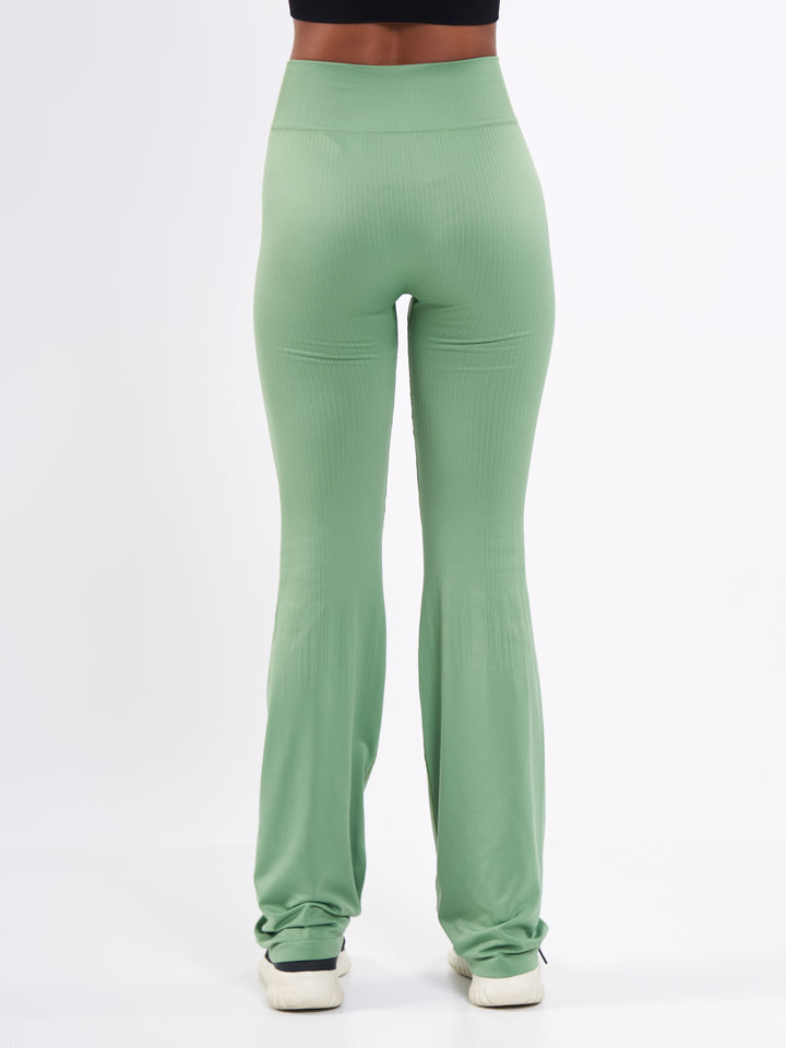 A Woman Wearing Misty Green Color Antigravity Seamless Flare-Leg Yoga Pants. Ultra-Light