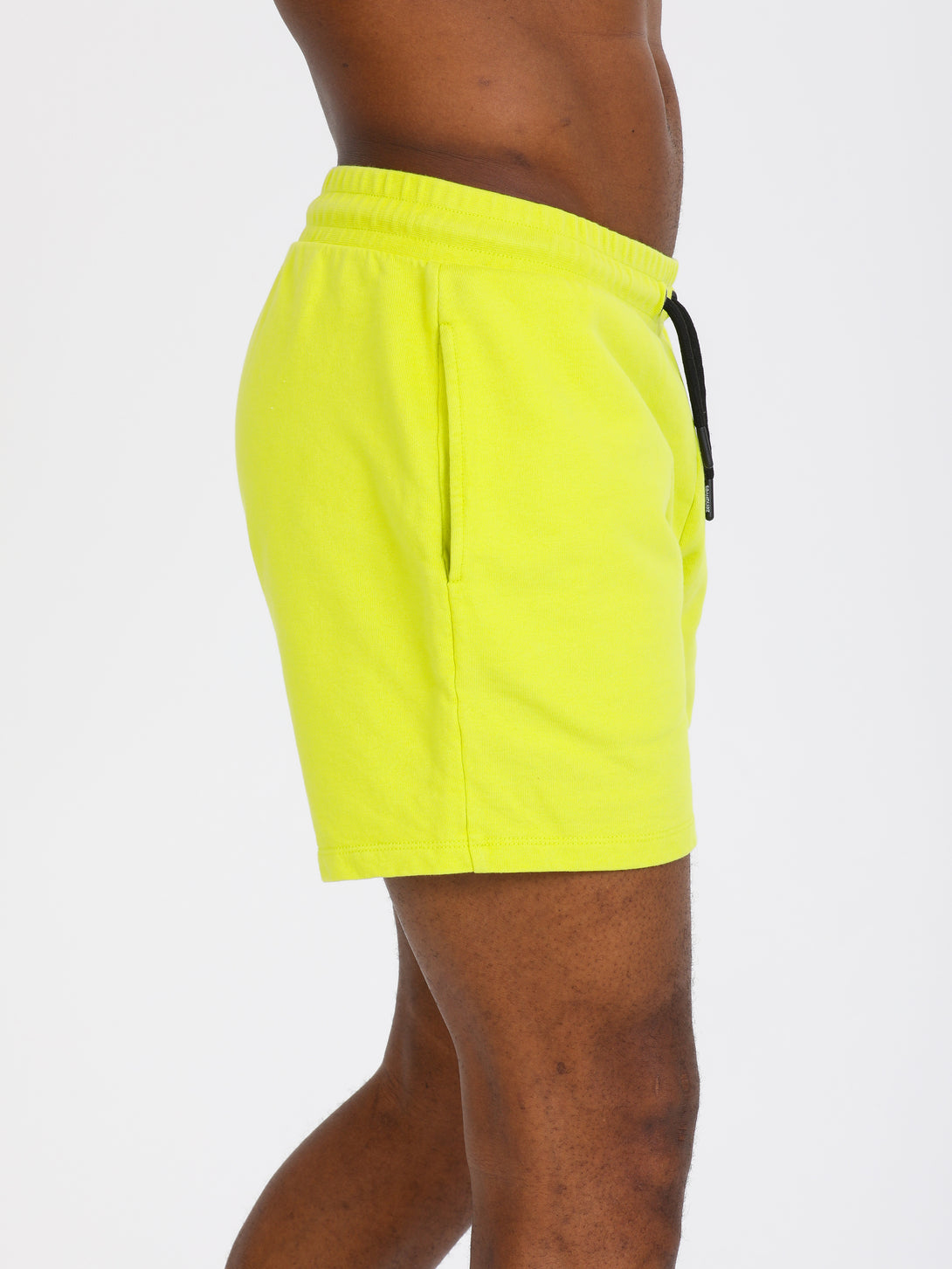 A Man Wearing Lime Color Essential Mens Workout Shorts