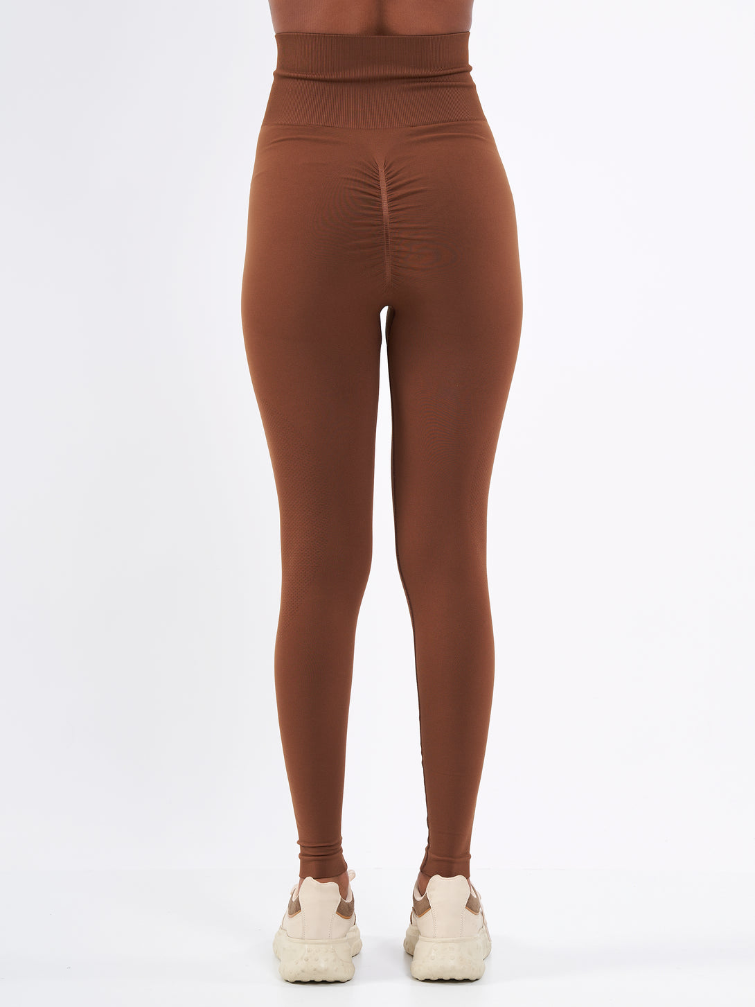 A Women Wearing Toffe Brown Color Zen Confidence Seamless Compressive Leggings. Body-Shaping