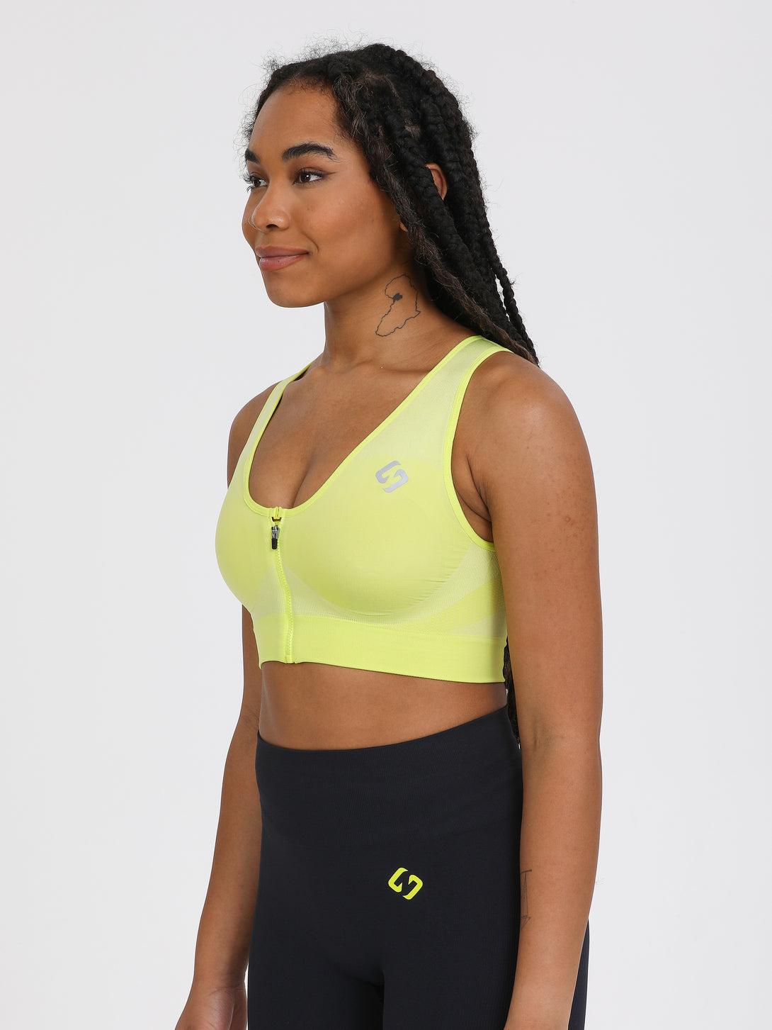 A Woman Wearing Lime Color High Impact Sports Bra