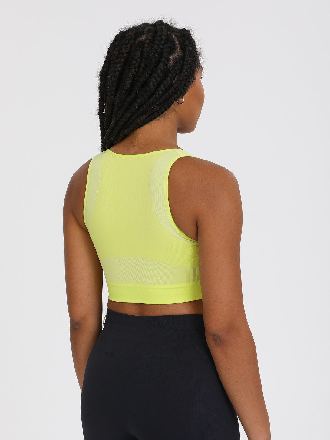 A Woman Wearing Lime Color High Impact Sports Bra