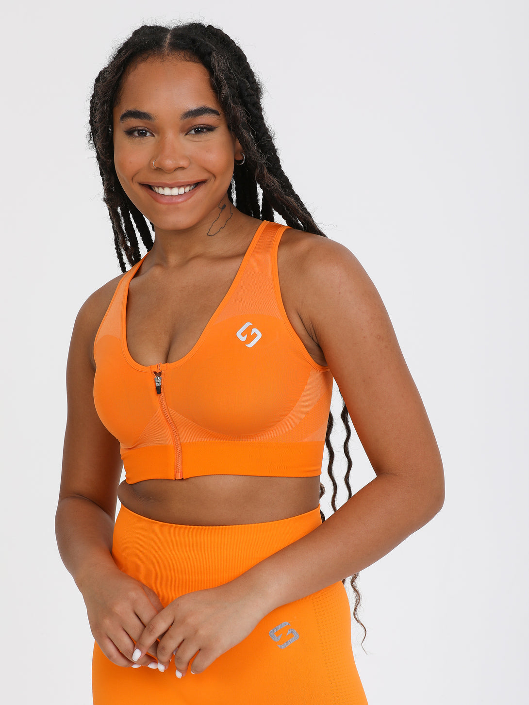 A Woman Wearing Orange Color High Impact Sports Bra