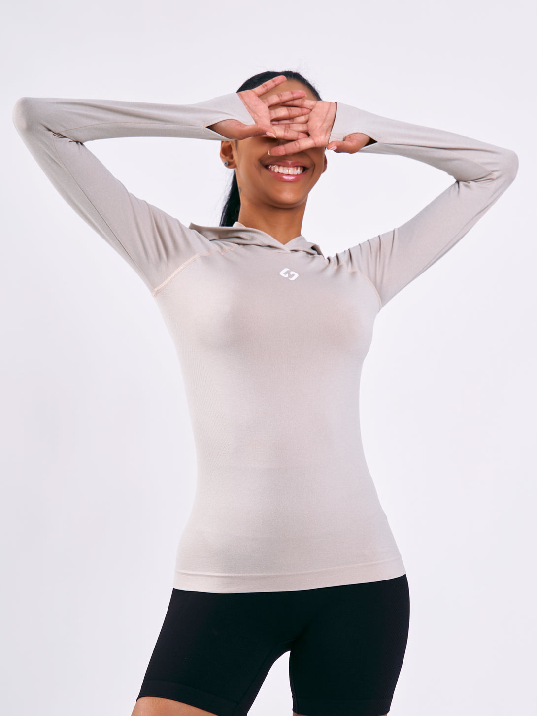 A Woman Wearing Light Beige Color Seamless Lightweight Hoodie