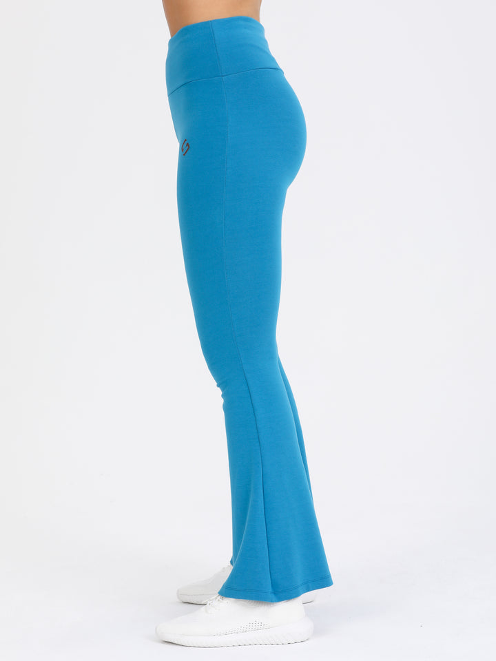 A Woman Wearing Blue Lagoon Color Legacy Jersey Yoga Pants