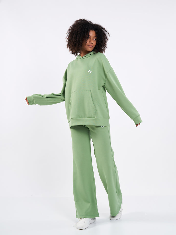 A Woman Wearing Misty Green Color Durable Oversized Comfort Hoodie for All-Day Wear
