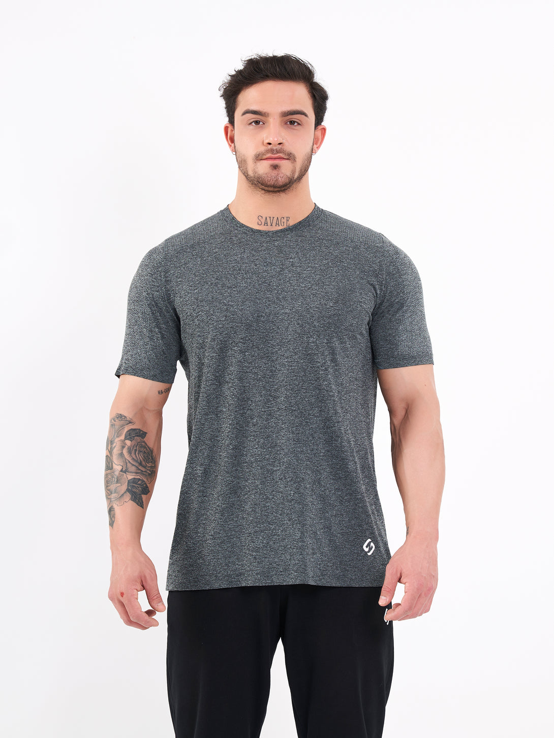 A Man Wearing Deep Black Color Unisex Seamless Melange T-Shirt. Enhanced Comfort
