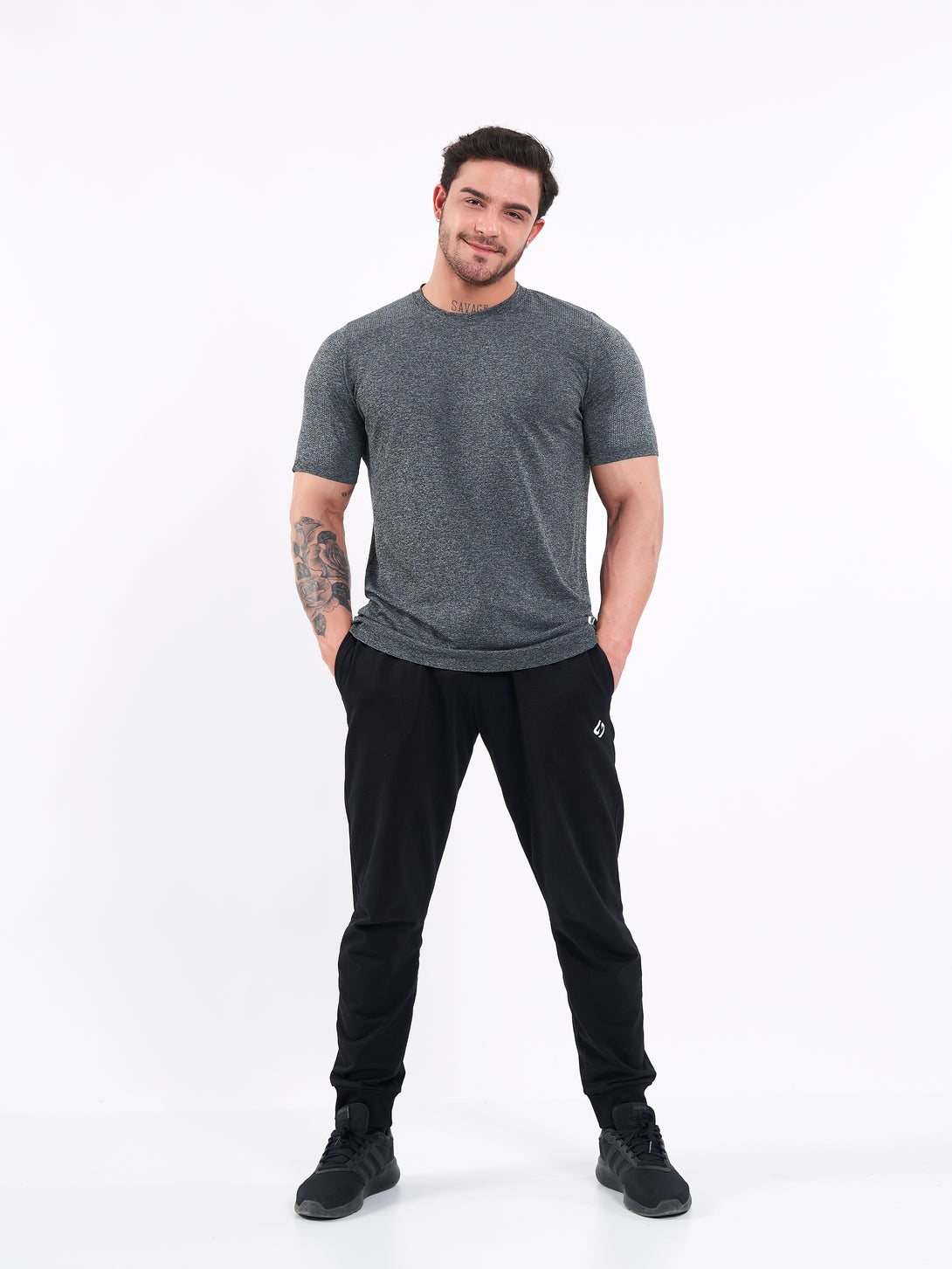 A Man Wearing Deep Black Color Unisex Seamless Melange T-Shirt. Enhanced Comfort