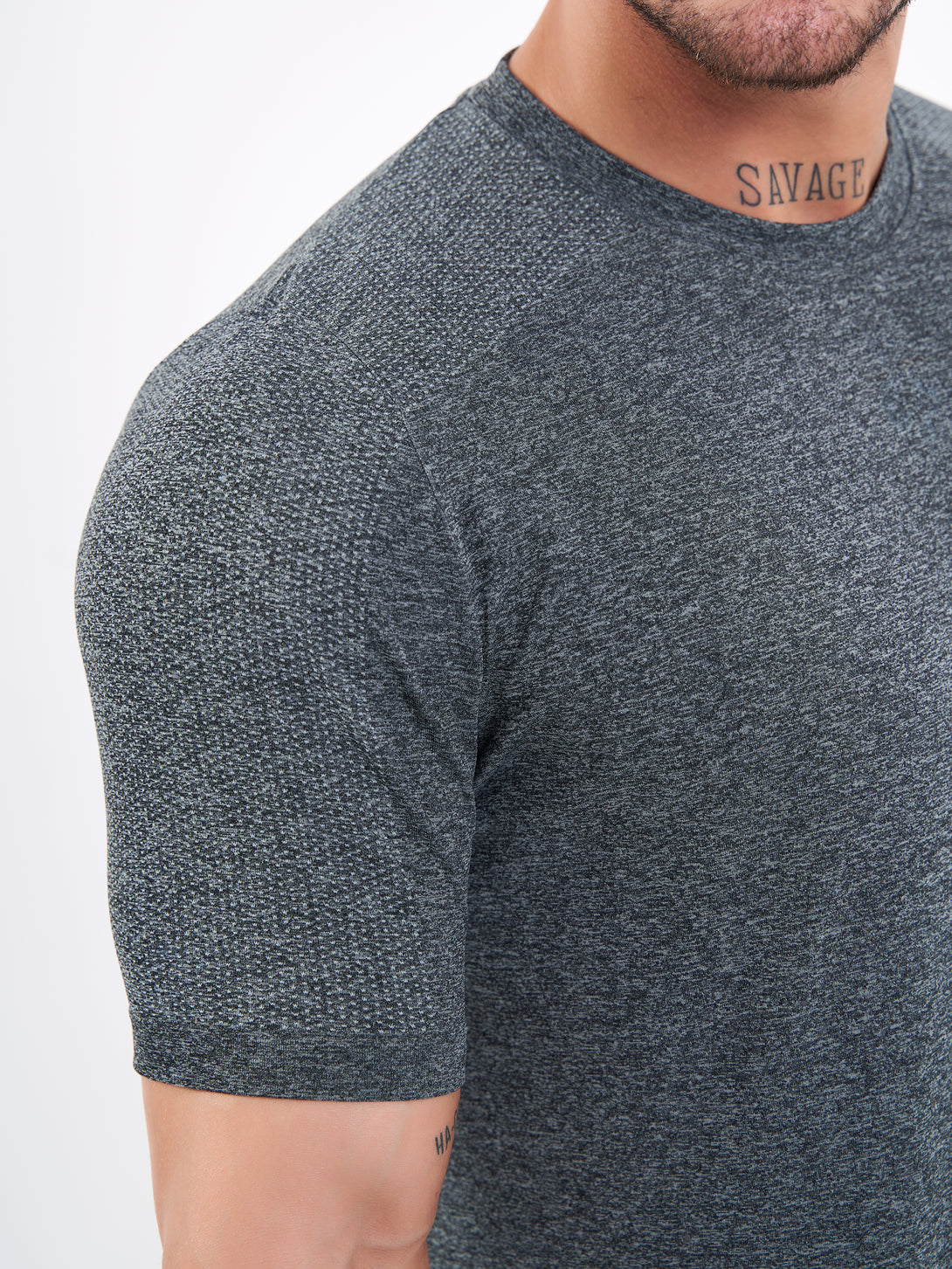 A Man Wearing Deep Black Color Unisex Seamless Melange T-Shirt. Enhanced Comfort
