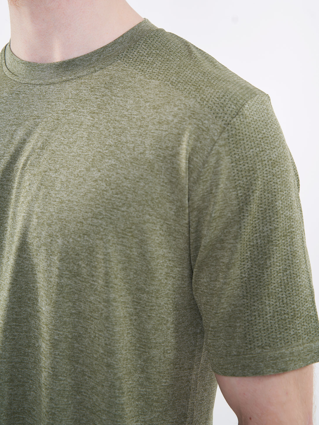 A Man Wearing Zen Khaki Color Unisex Seamless Melange T-Shirt. Enhanced Comfort