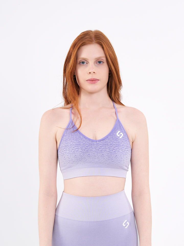 A Woman Wearing Pasiley Purple Color Seamless Low-Impact Sports Bra with Ombre Effect. Chic Comfort