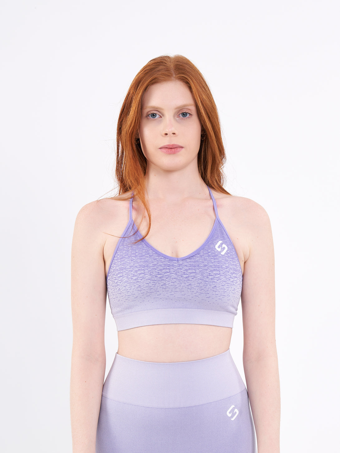 A Woman Wearing Pasiley Purple Color Seamless Low-Impact Sports Bra with Ombre Effect. Chic Comfort