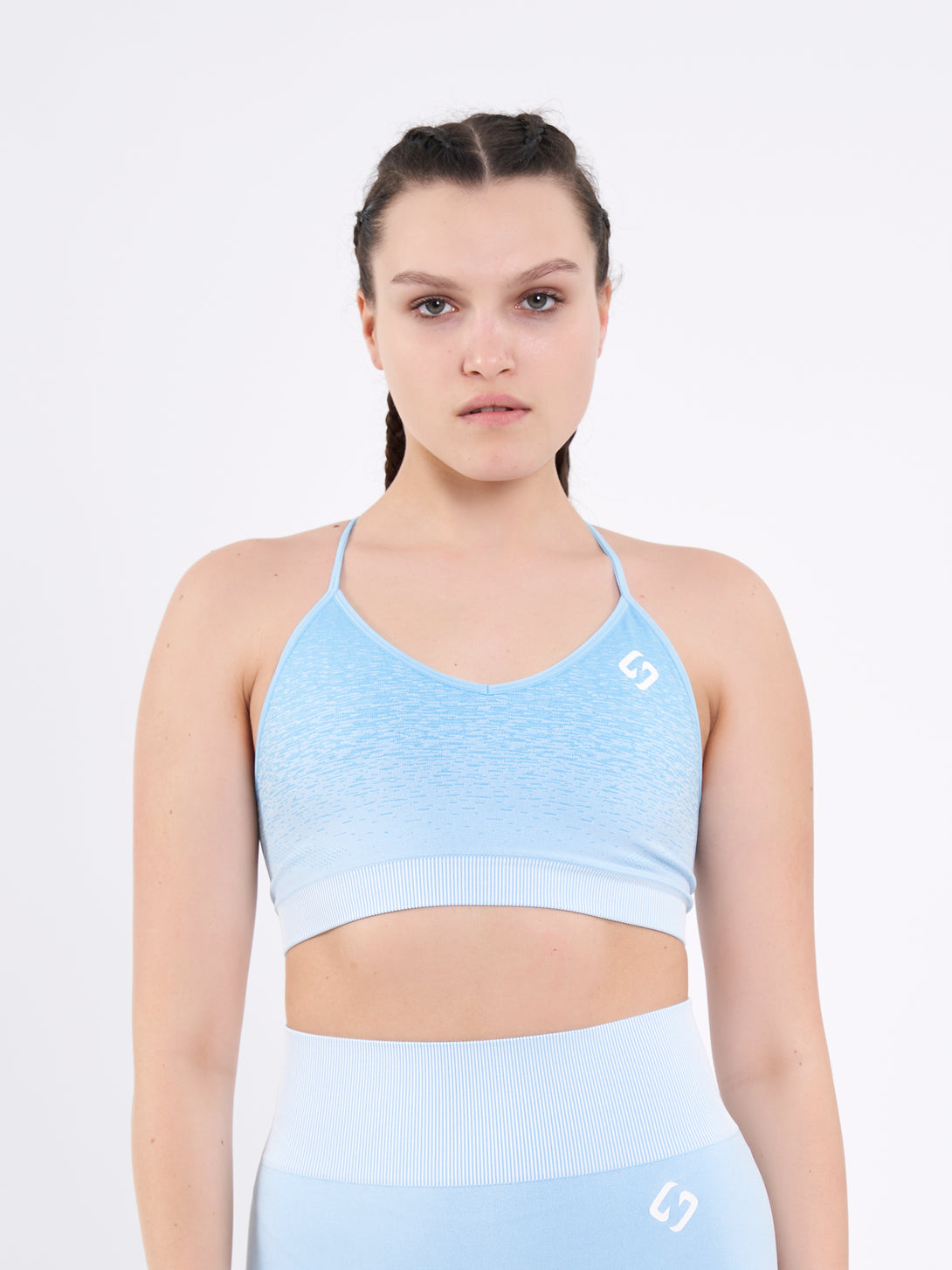 A Woman Wearing Sky Blue Color Seamless Low-Impact Sports Bra with Ombre Effect. Chic Comfort