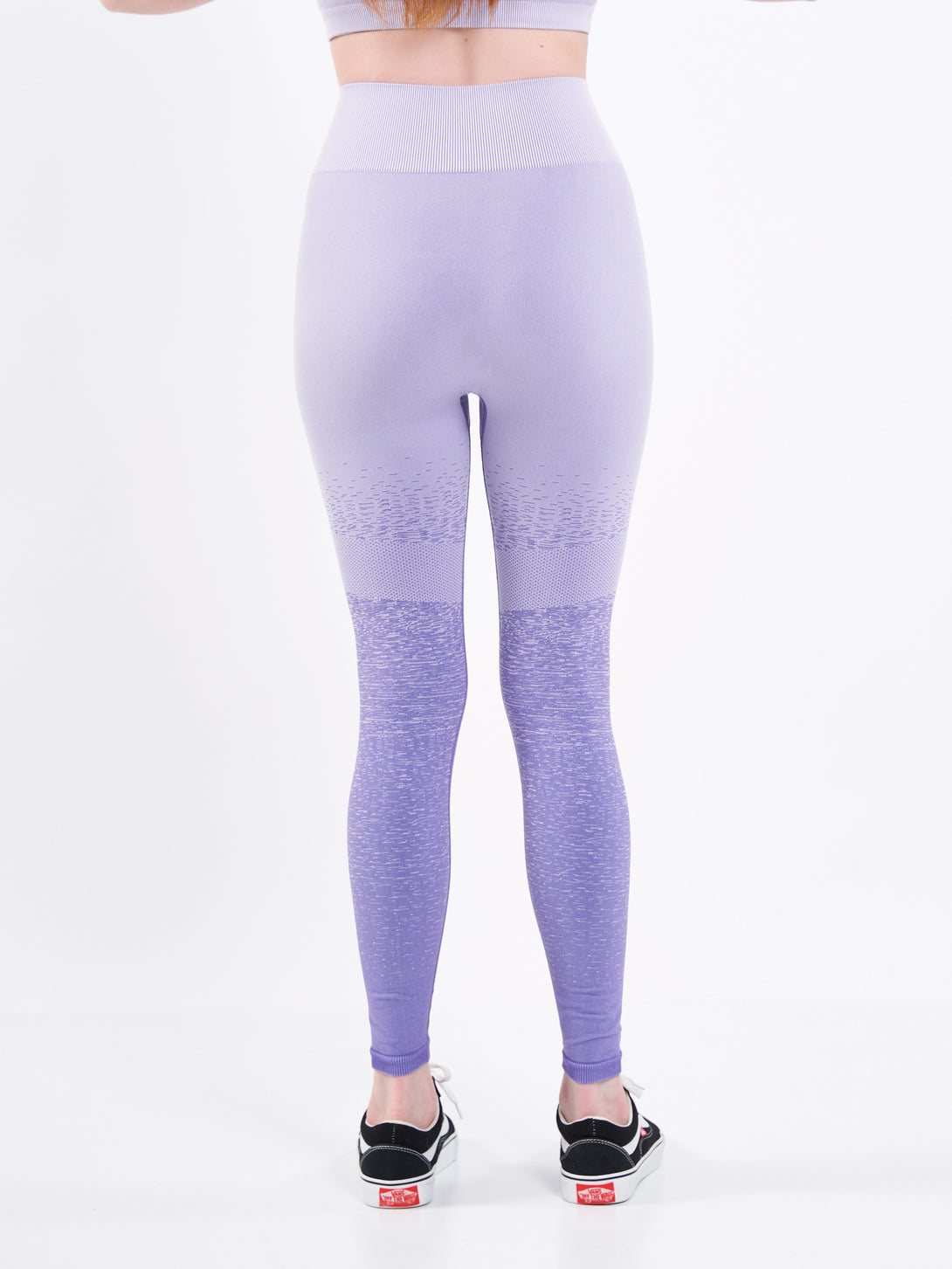 A Women Wearing Paisley Purple Color Seamless High-Waist Leggings with Ombre Effect. Chic Comfort