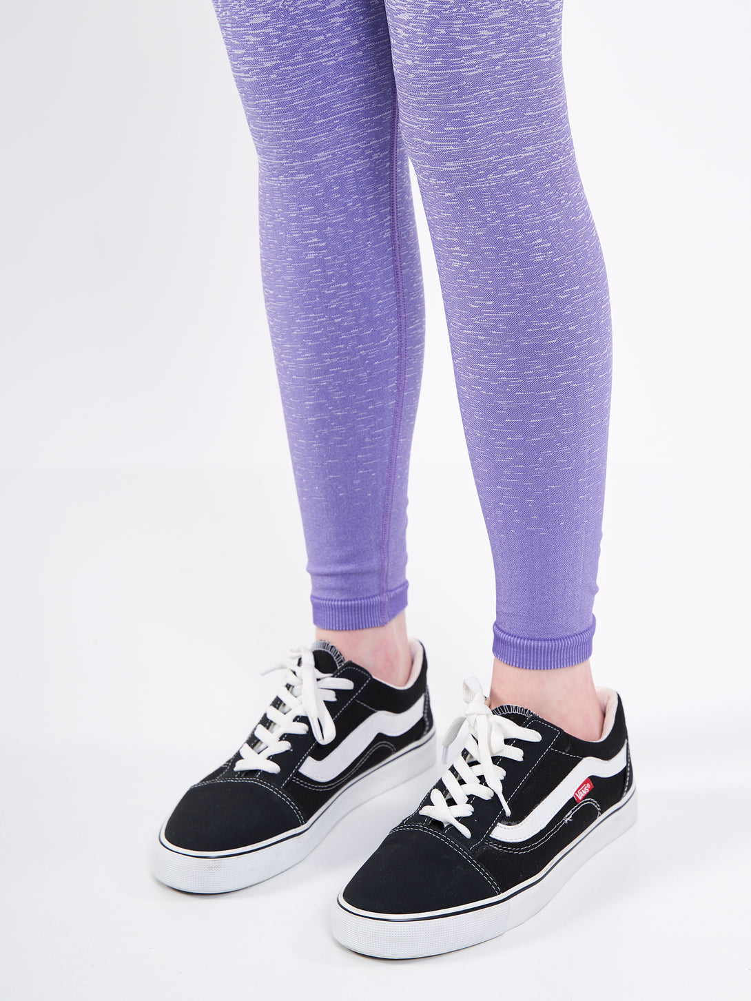 A Women Wearing Paisley Purple Color Seamless High-Waist Leggings with Ombre Effect. Chic Comfort