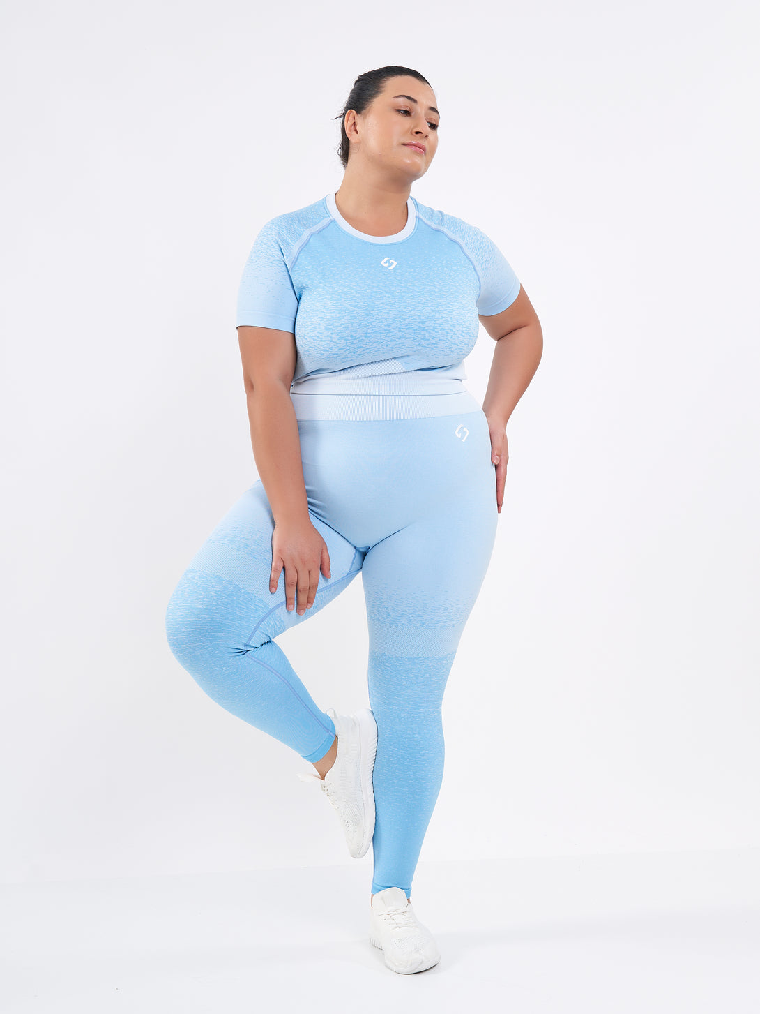 A Women Wearing Sky Blue Color Seamless High-Waist Leggings with Ombre Effect. Chic Comfort
