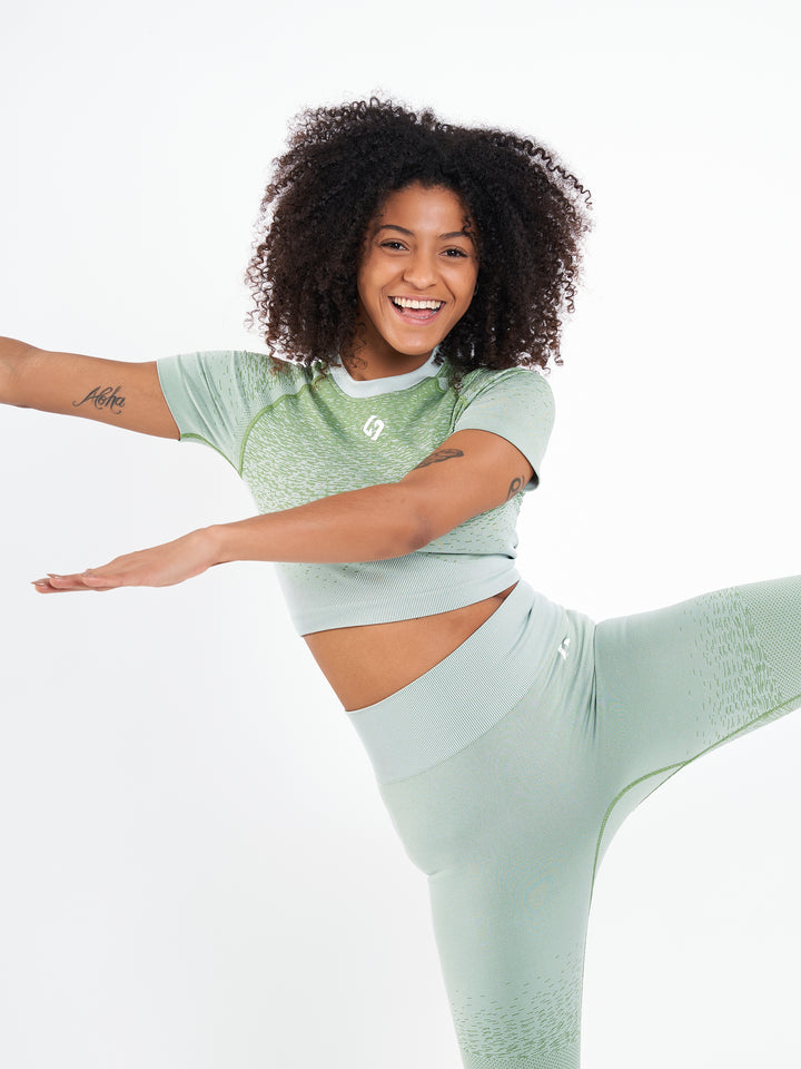 A Woman Wearing Misty Green Color Seamless Crop Top with Ombre Effect. Chic Comfort